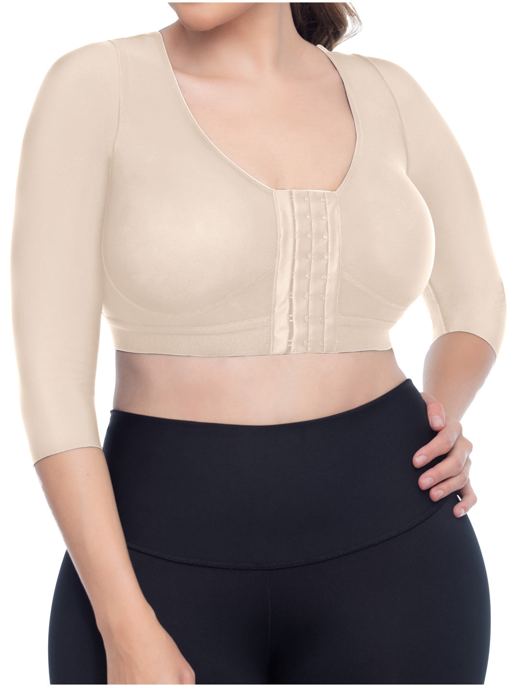 Beige crop top with black leggings on a white background