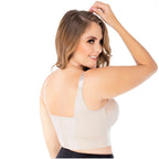 Woman wearing a white tank top on a white background