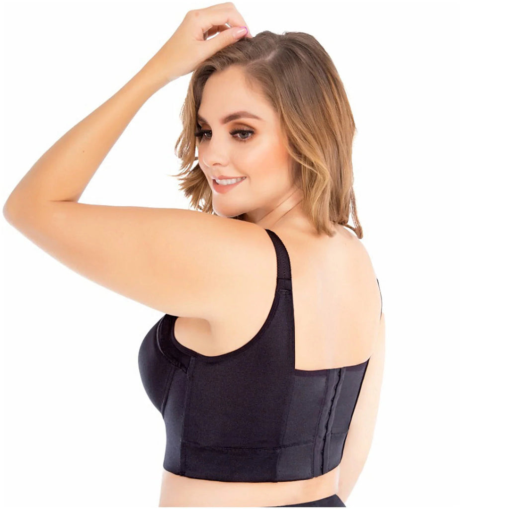 Woman wearing a black waist trainer on a white background