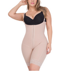 Woman wearing a beige body shaper with a black bra on a white background