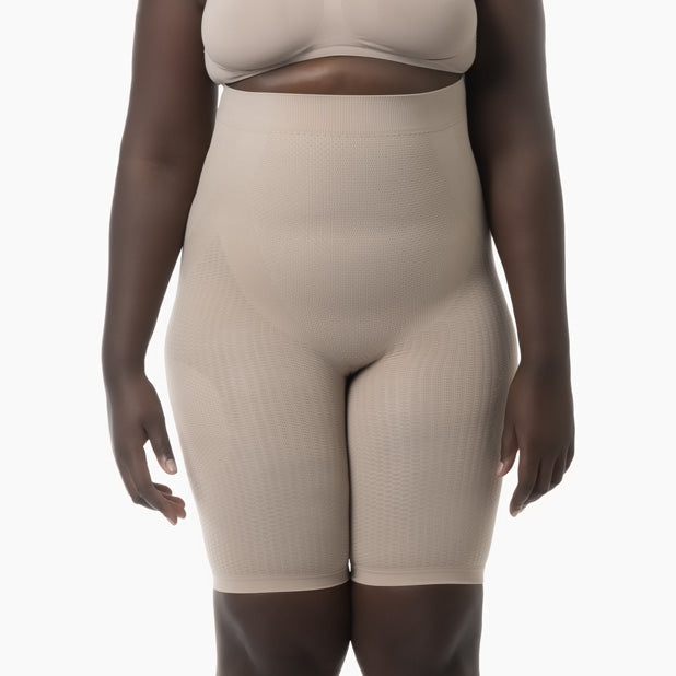 Beige shapewear worn by a model on a white background