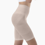 Beige compression shorts worn by a person on a white background