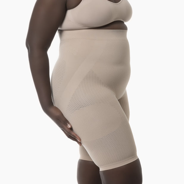 Beige shapewear worn by a person on a white background