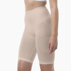 Beige shapewear shorts worn by a person on a white background