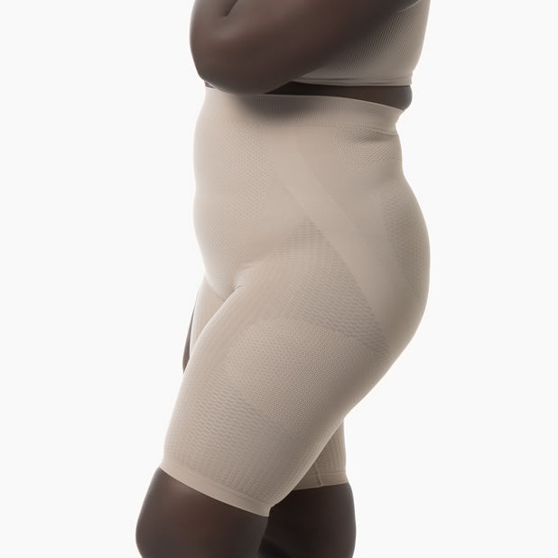 Beige shapewear worn by a person on a white background