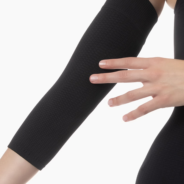 Black arm sleeve worn on a white background