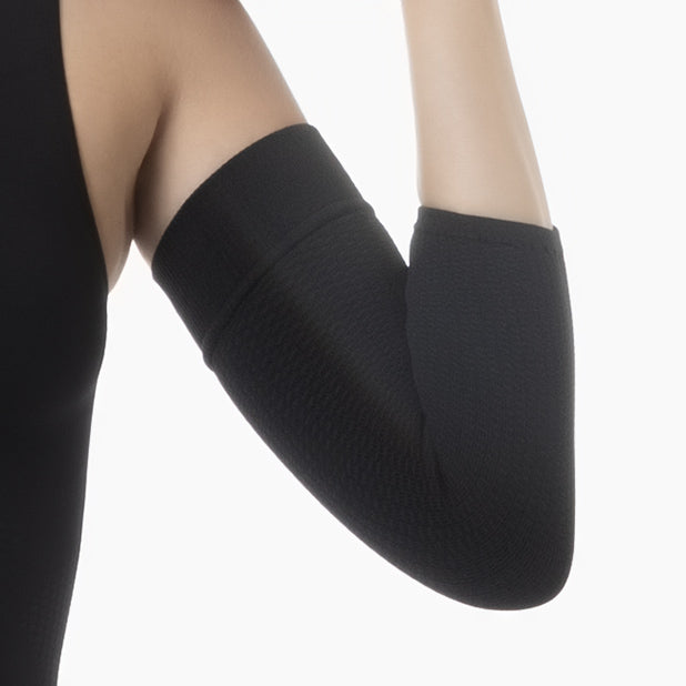 Black knee-high socks worn by a person on a white background