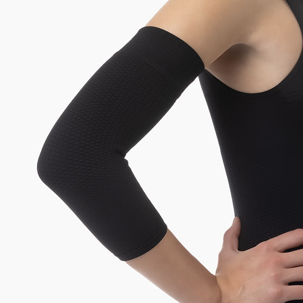 Black arm sleeve worn by a person on a white background