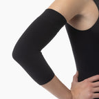 Black arm sleeve worn by a person on a white background