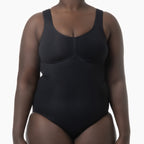 Black bodysuit worn by a person on a white background
