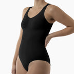 Black bodysuit worn by a model on a white background
