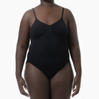 Black one-piece swimsuit worn by a model on a white background