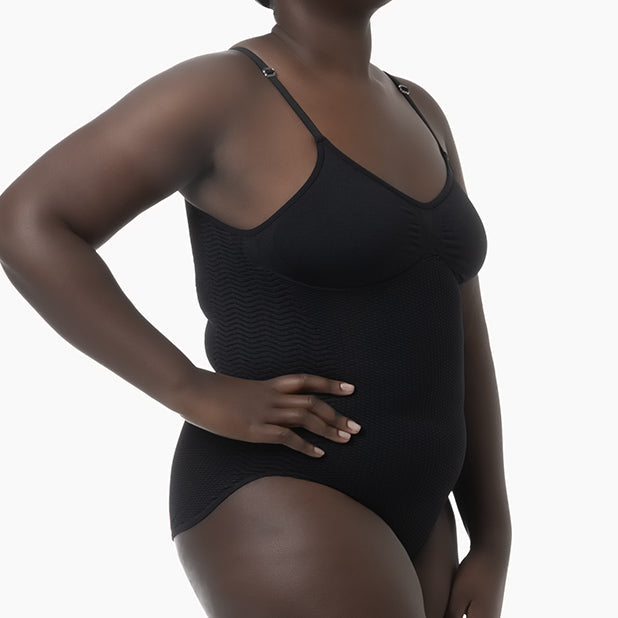 Black bodysuit worn by a model on a white background