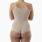 Beige bodysuit worn by a person on a white background