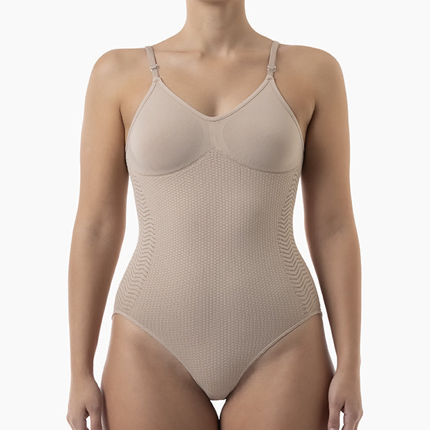 Beige bodysuit worn by a model on a white background