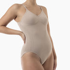 Beige bodysuit worn by a model on a white background
