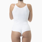 White ribbed tank top worn by a person on a white background