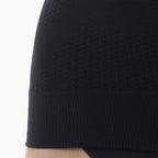 Close-up of a black textured sleeveless top on a white background