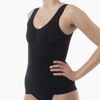 Black tank top worn by a person on a white background