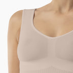 Beige tank top worn by a person on a white background