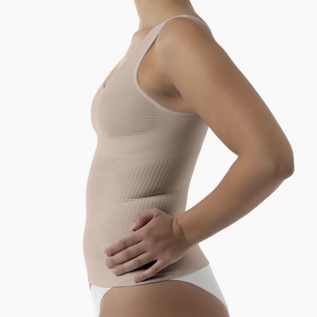 Beige compression garment worn by a person on a white background