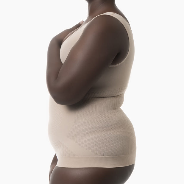 Beige shapewear worn by a model on a white background