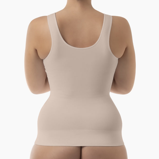 Beige tank top worn by a person on a white background