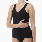 Black tank top worn by a model on a white background