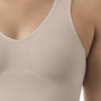 Beige tank top worn by a person, focusing on the neckline and shoulder area.