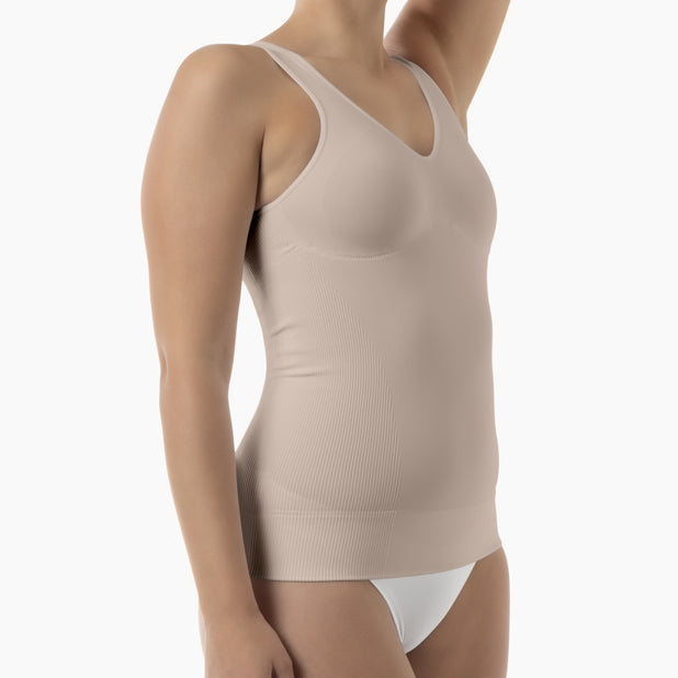 Beige compression garment worn by a person on a white background