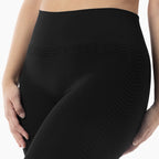 Black leggings with textured pattern worn by a person on a white background