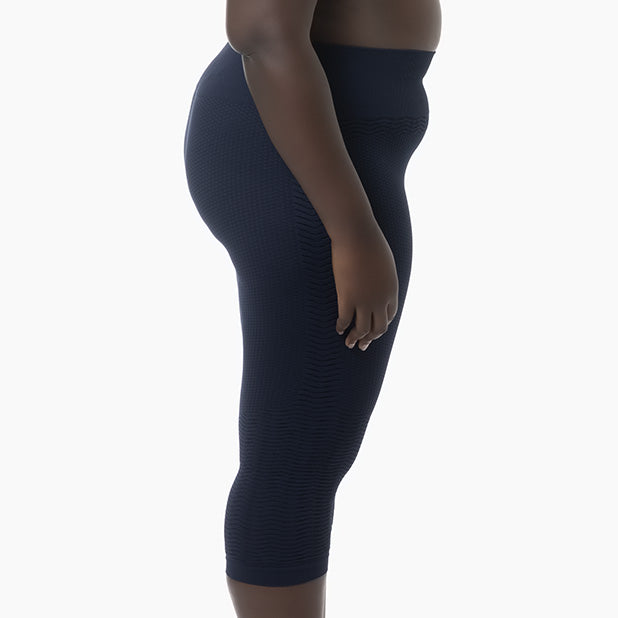 Navy blue leggings worn by a person on a white background