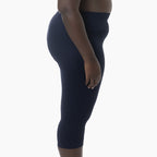 Navy blue leggings worn by a person on a white background