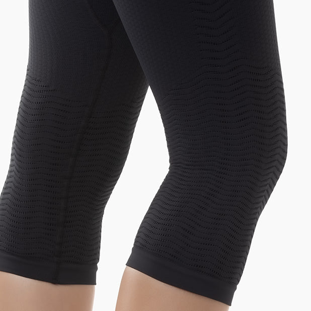 Black textured leggings on a white background