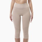 Beige compression leggings worn by a model on a white background