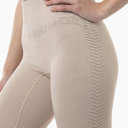 Beige compression garment on a person against a white background