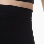 Close-up of black pants with a white background