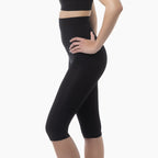 Black capri leggings worn by a person on a white background