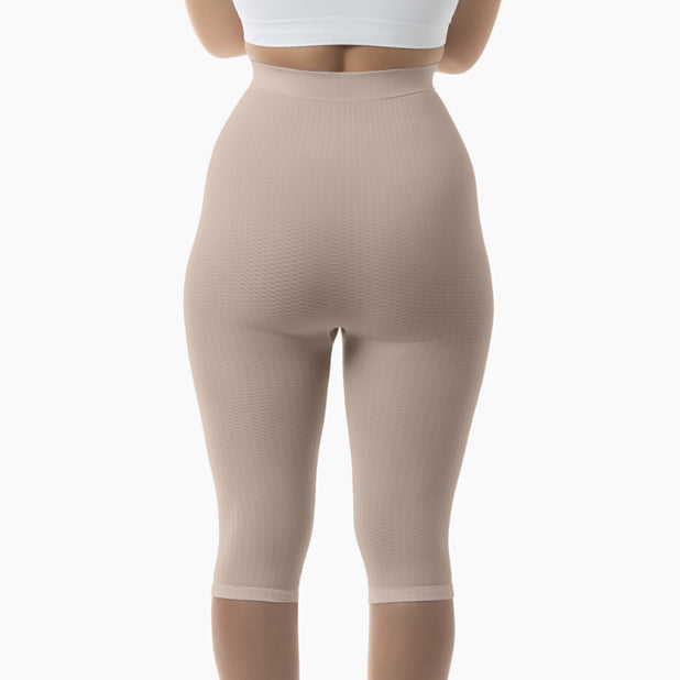 Beige shapewear leggings worn by a person on a white background