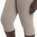 Beige textured leggings worn by a mannequin on a white background
