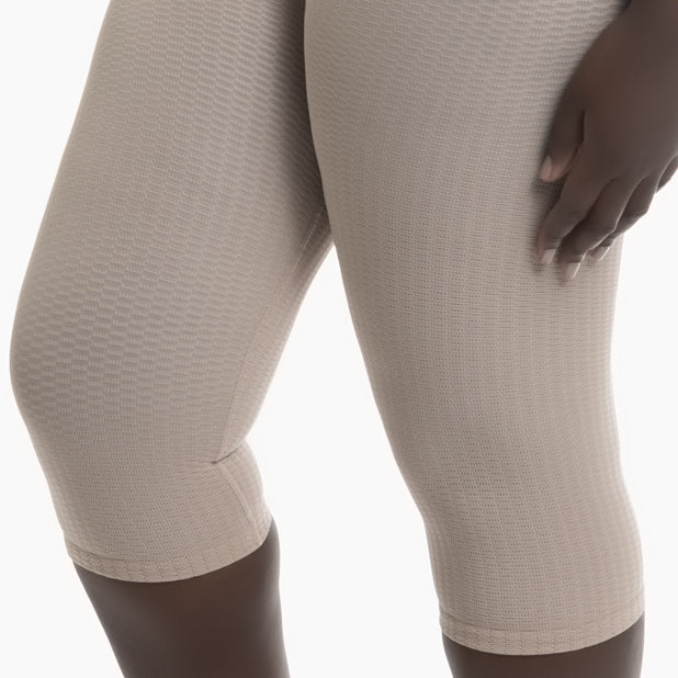 Beige textured leggings worn by a mannequin on a white background