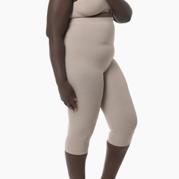 Beige ribbed leggings worn by a person on a white background