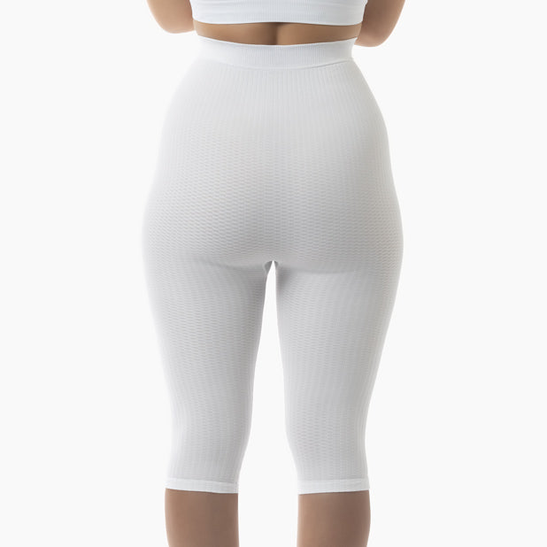 White ribbed leggings worn by a person on a white background