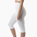White compression shorts worn by a person on a white background