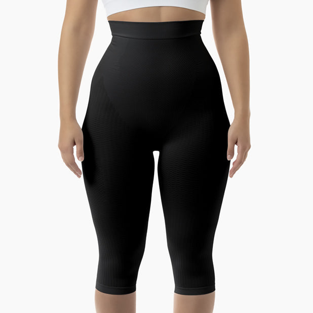 Black capri leggings worn by a person on a white background