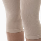 Close-up of beige knee-high socks on a white background