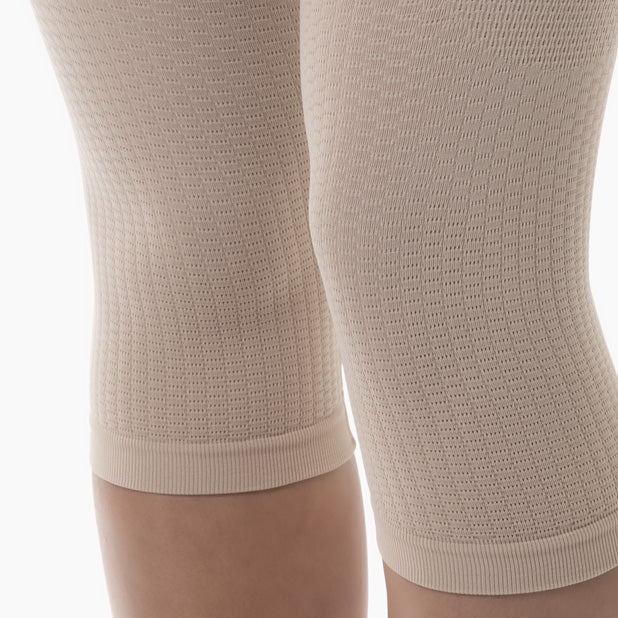 Close-up of beige knee-high socks on a white background