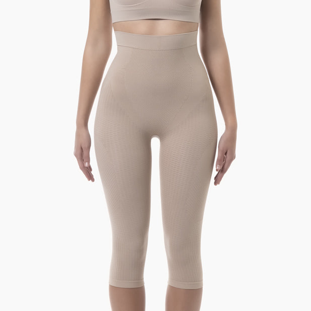 Beige leggings worn by a person on a white background