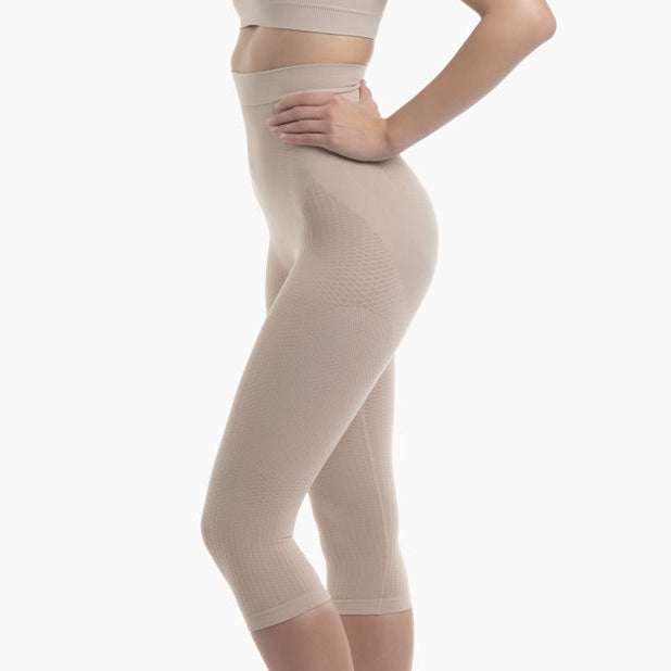Beige shapewear leggings worn by a person on a white background