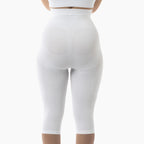 White leggings worn by a person on a white background